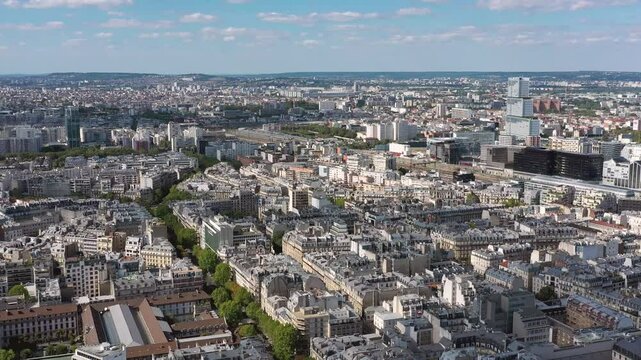 PARIS, FRANCE - OCTOBER 3, 2024: Aerial view of Paris showcases the intricate architecture and vibrant city life beneath a clear blue sky