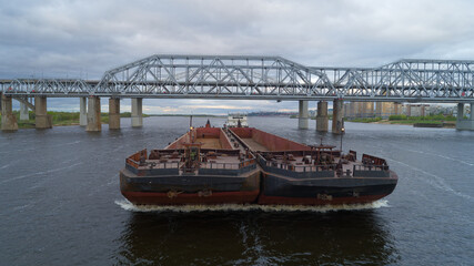 Large ship is crossing a bridge over a body of water