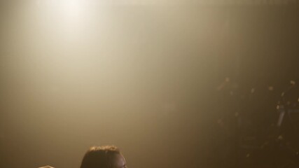 Young athletic woman in tight sportswear doing endurance exercise, jumping over box in the gym