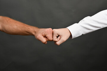 Clash of two fists. Concept of competition or approval.