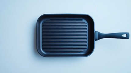 Black grill pan with ribbed surface on a light blue background for cooking and kitchenware branding purposes