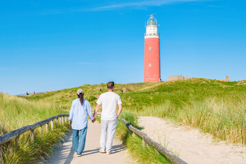 A couple leisurely walks along a scenic path near the Texel Lighthouse, enjoying the stunning...
