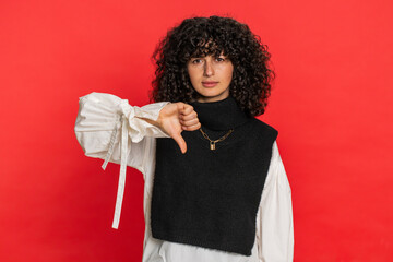 Dislike. Upset unhappy Caucasian woman showing thumbs down sign gesture, expressing discontent,...