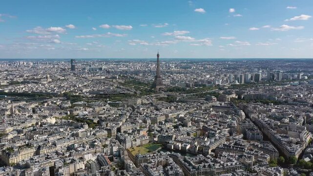 PARIS, FRANCE - OCTOBER 3, 2024: Aerial view of iconic Eiffel Tower surrounded by beautiful cityscape and blue skies
