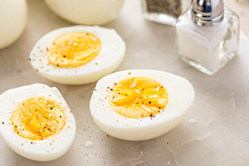 Soft boiled eggs cut in half with salt and pepper