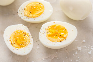 Soft boiled eggs cut in half with salt and pepper