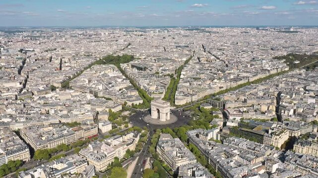 PARIS, FRANCE - OCTOBER 3, 2024: Aerial view of iconic Arc de Triomphe and the Paris cityscape showcasing bustling streets and green spaces