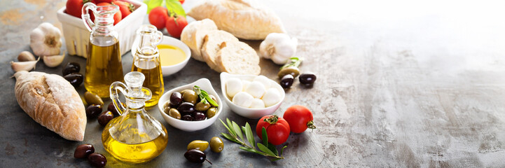 Olive oil in vintage bottles and italian cuisine ingredients