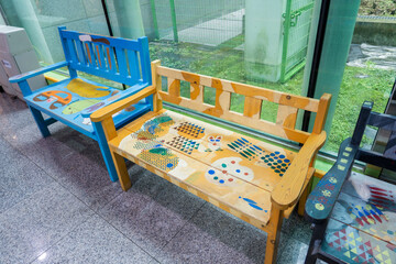 Colorful wooden kids chairs on kids museum