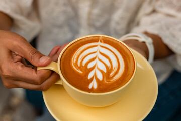 Close up white coffee cup with heart shape latte art,coffee latte in coffee shop cafe.