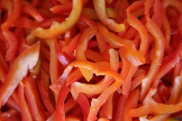  A close-up of freshly sliced red bell peppers, showcasing their vibrant color and crisp texture. The image is perfect for culinary and food-related projects.