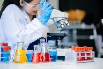 Discover a dedicated scientist conducting laboratory research, using pipettes, microscopes, and lab...
