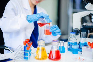 Discover a dedicated scientist conducting laboratory research, using pipettes, microscopes, and lab...
