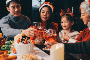 Happy multigeneration family enjoying in opening gifts on Christmas eve at home.
