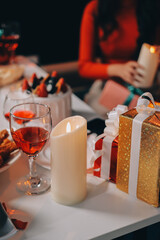 Multi-Generation Family Celebrate Christmas At Home Wearing Santa Hats And Antlers Opening Presents