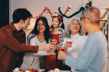 Merry Christmas! Happy family are having dinner at home. Celebration holiday and togetherness near tree.