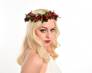 close up portrait of beautiful blonde female model wearing holly and ivy Christmas  fantasy wreath...