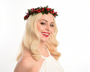 close up portrait of beautiful blonde female model wearing holly and ivy Christmas  fantasy wreath...