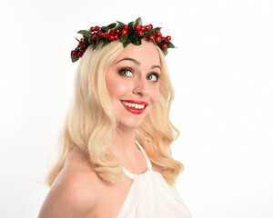 close up portrait of beautiful blonde female model wearing holly and ivy Christmas  fantasy wreath...