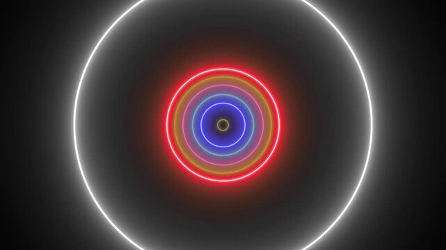 Seamless futuristic abstract background with neon effect.  Circles of various colors that grow and shrink with neon effects and a black background.