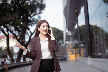 Asian businesswoman chatting in the city center