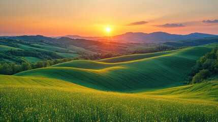 Fototapeta premium Nature background with rolling green hills under a vibrant sunrise