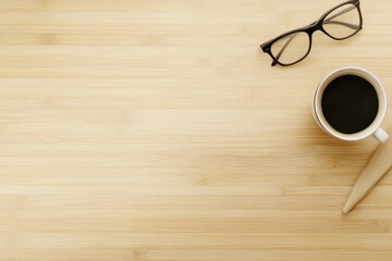Overhead view of a minimalist workspace with coffee, eyeglasses, and copy space on a light wood desk.