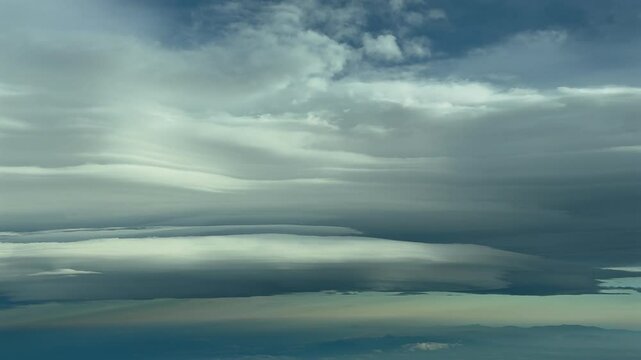 immersive pilot&rsquo;s POV FPV flying through a dramatic winter sky with some winding clouds ahead, as seen from the cokpit of a jet flying at cruise. 4K 60FPS