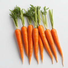 Fresh bunch of vibrant orange carrots with green tops on light background