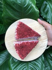 Red velvet mille crepe served on a wooden platter