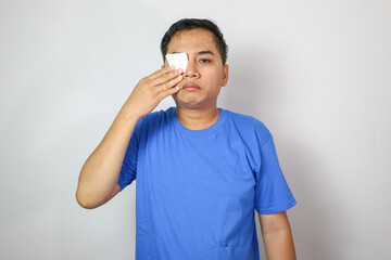 Fototapeta premium Boy with blindfolded bandaged eye plaster for surgery, treatment, pink eye, hordeolum, strabismus, lazy eye, hygienic, prevent infection, protect dust,smiling and eye injury.