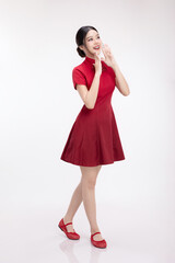 Full body portrait of joyful beauty Asian woman in red Cheongsam Chinese traditional dress celebrating on Chinese New Year festival.