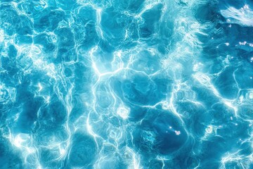 Vibrant blue water with sunlight reflections, creating a shimmering texture. Ideal for summer, travel, or relaxation themed designs; evokes tranquility and peace.