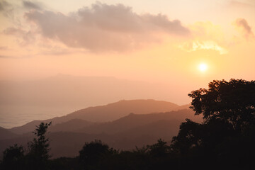 landscape and travel concept with sunrise and layer of mountain and mist with forest on morning