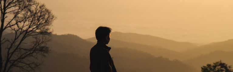 landscape and travel concept with man see sunrise and layer of mountain and mist with forest on...