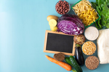 Foods containing complex carbohydrates and a dark board for inscriptions on a light background