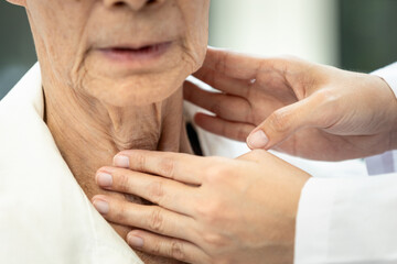 Close up,Hands of doctor,touching neck of an old elderly,examining thyroid disease,problems with...