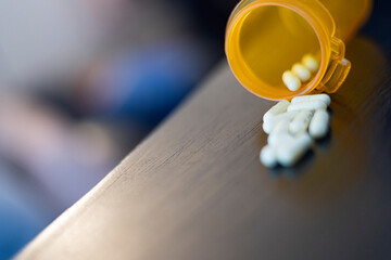 A spilled bottle of prescription medication capsules