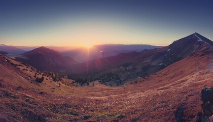 Naklejka premium A beautiful mountain landscape with snow-capped peaks during sunset and sunrise