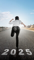 Rear view of businessman run with 2025 number written on asphalt road