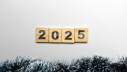 Wooden blocks with number 2025 and christmas ornament on white background