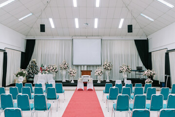 Wedding blessing backdrop featuring a beautifully arranged table, chairs, and a podium