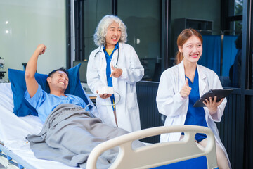 Two female doctors examine a patient lying on a hospital bed,discuss the medical chart,administer medicine,and provide encouragement, ensuring compassionate care and fostering the patient's recovery