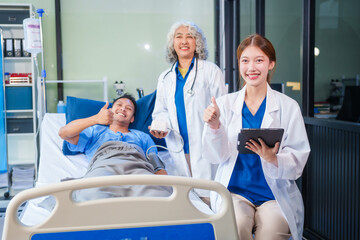 Obraz premium Two female doctors examine a patient lying on a hospital bed,discuss the medical chart,administer medicine,and provide encouragement, ensuring compassionate care and fostering the patient's recovery