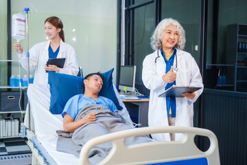 Fototapeta premium Two female doctors examine a patient lying on a hospital bed,discuss the medical chart,administer medicine,and provide encouragement, ensuring compassionate care and fostering the patient's recovery
