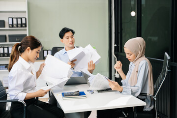  Asian businesspeople while collaborating on a new project.  using a laptop and tablet