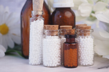 Homeopathic pills containers on a table 