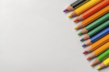 Obraz premium Colorful pencils arranged on white background, showcasing vibrant hues and sharp tips, perfect for artistic creativity and drawing