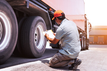 Truck Driver is Checking Daily Checklist of Truck Wheels. 
Trailer Truck Wheels Tires.  Maintenance Safety The Truck. Inspection Safety of Transport. Logistics Transportation.