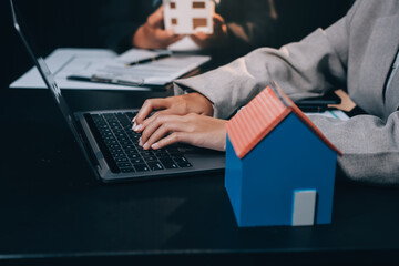 Close up Business people or Real Estate agent explain signing agreement for sale house to client. Property, Insurance, Broker concept.